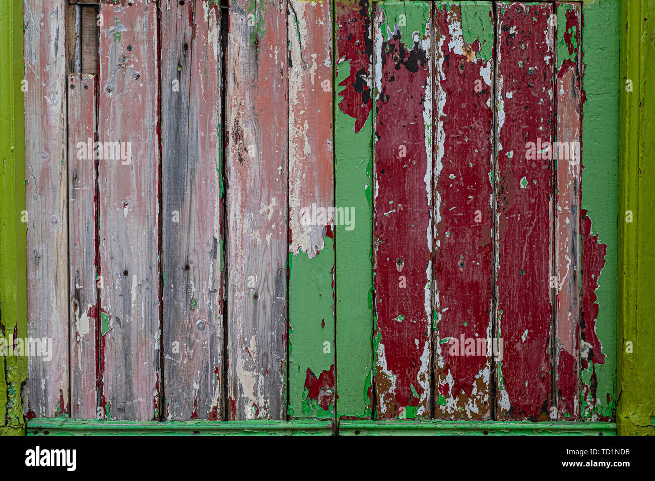 A Rustic Weathered Wood Panel Door With The Paint Peeling