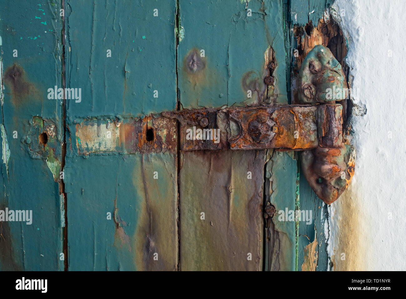 A Broken Rusting Door Hinge On A Painted Wooden Door Paint