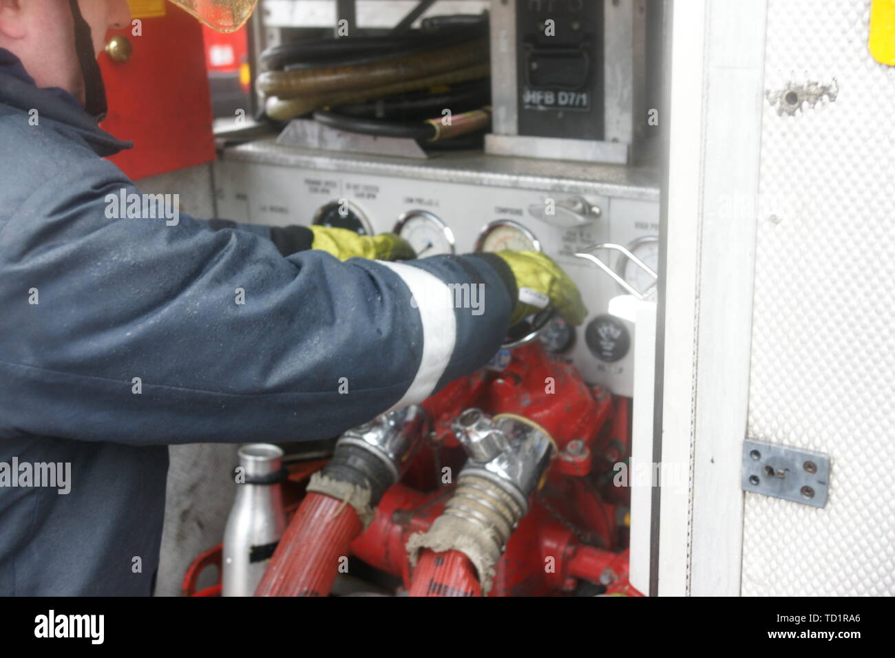 fire fighter operating fire engine pump Stock Photo Alamy