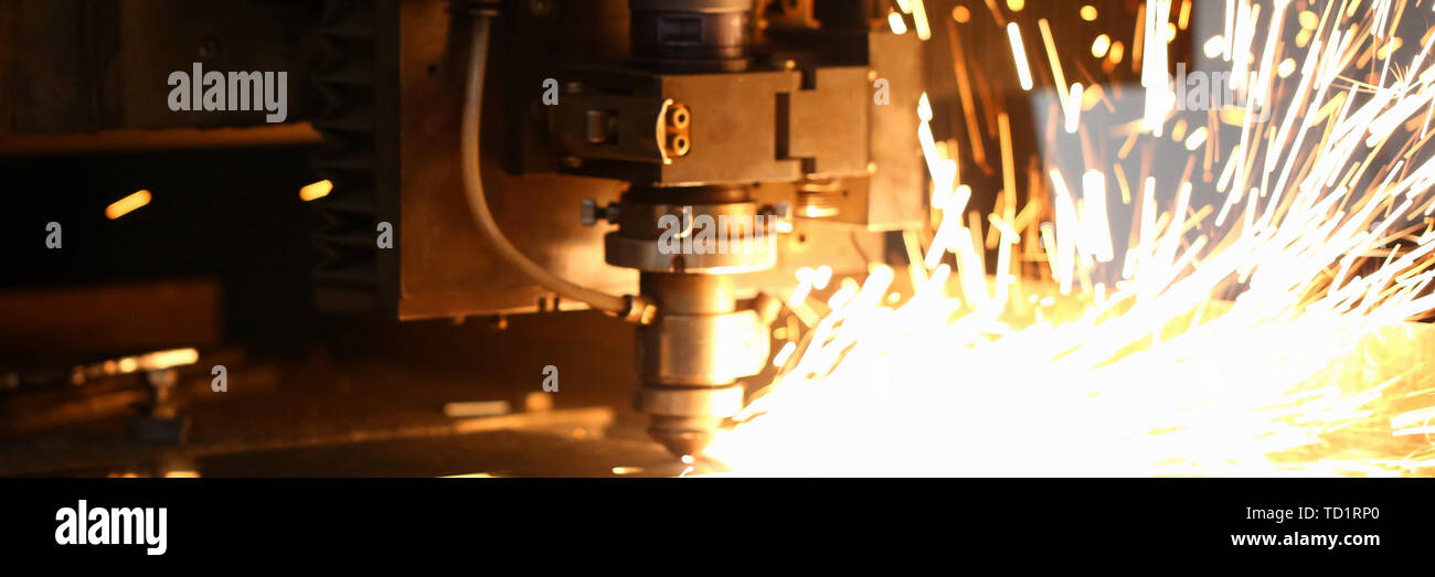 Sparks fly out machine head for metal processing Stock Photo