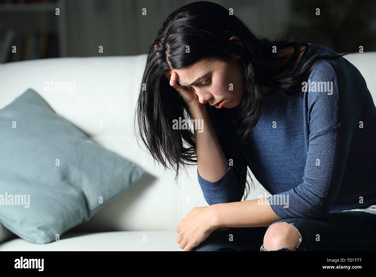 Sad Woman Complaining Alone Sitting On A Couch In The Dark Night