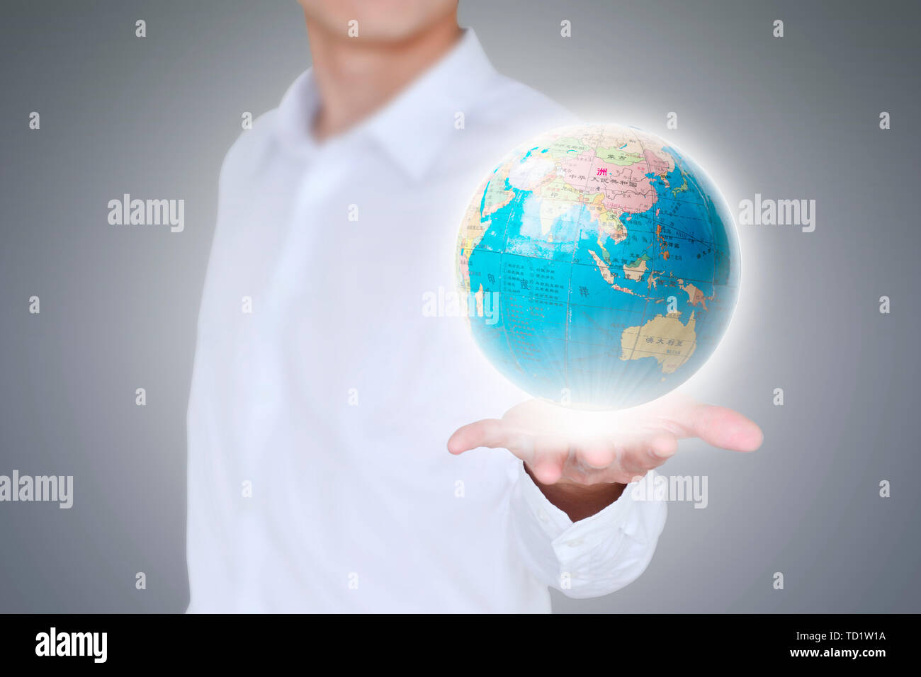 Business man holds the earth in his hands Stock Photo - Alamy