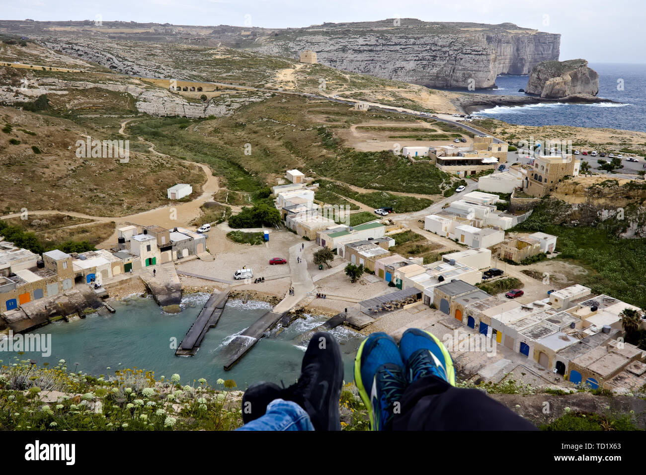 Inland sea (diving spot) with little houses and fungus rock in the background seen from above in gozo, Malta. Stock Photo