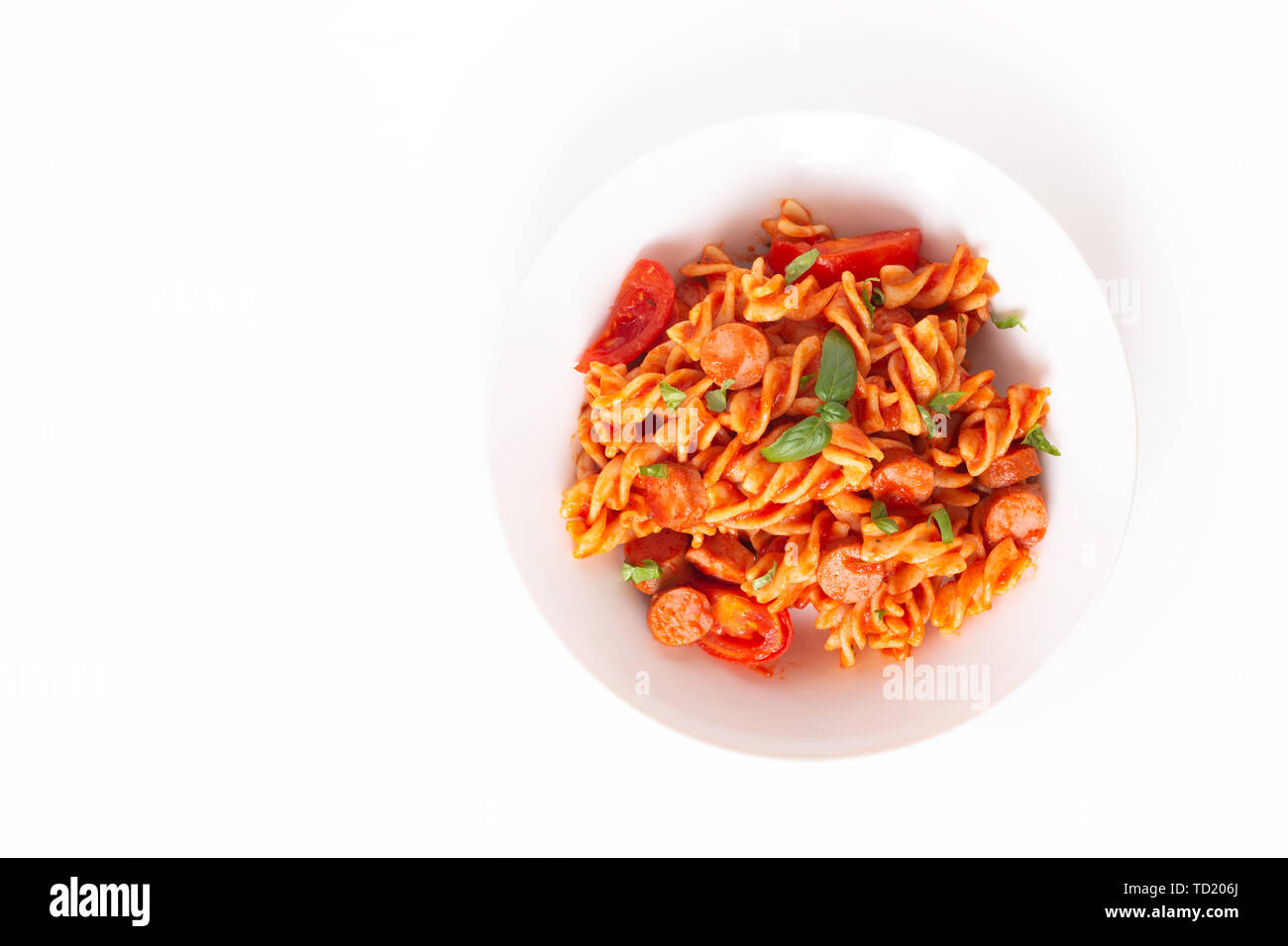 Food concept Homemade Fusilli pasta with tomato sauce in a white dish on white background Stock Photo