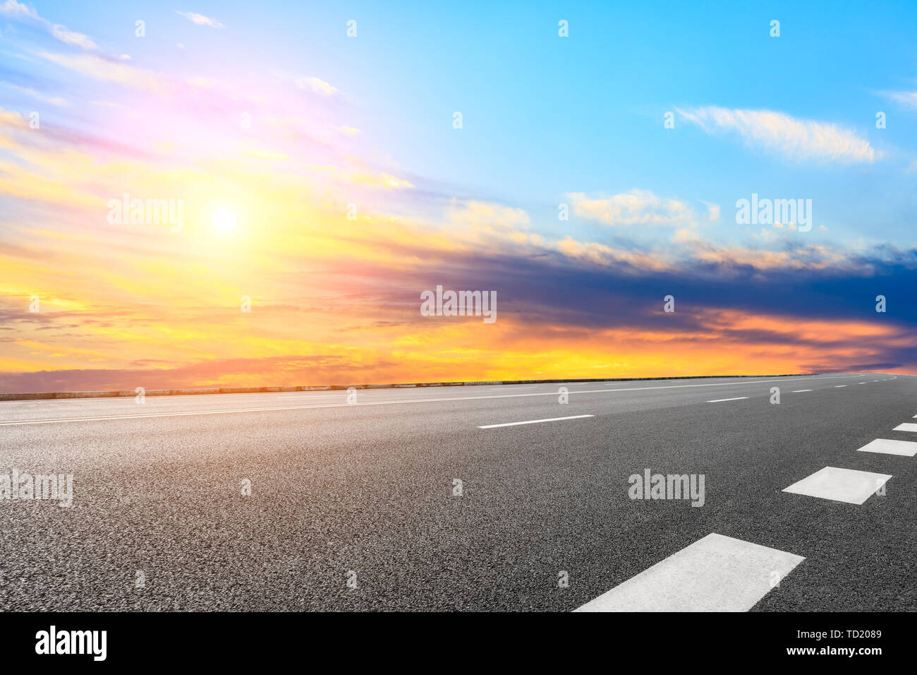 Asphalt road and sunset sky Stock Photo - Alamy