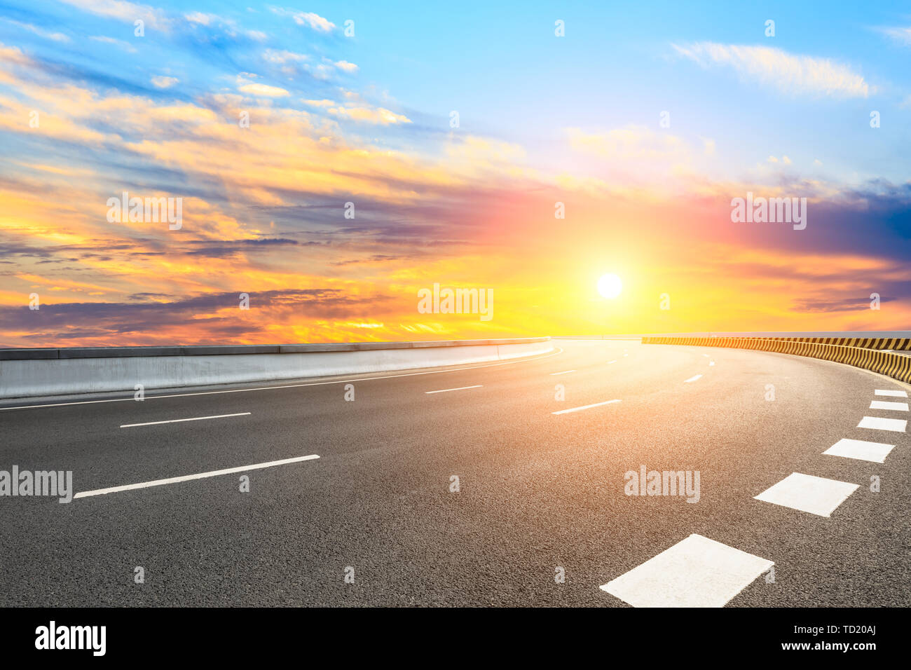 Asphalt road and sunset sky Stock Photo - Alamy