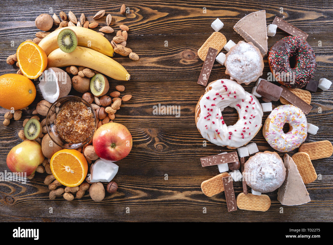 Unhealthy and healthy sweets on wooden background. Organic and dietary