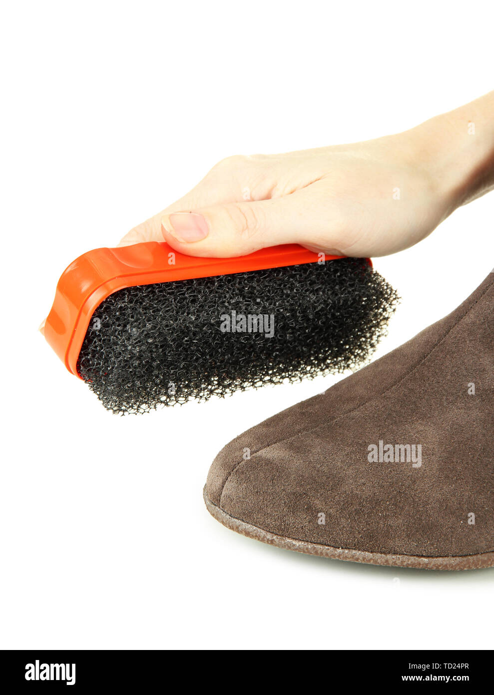 Hand with brush cleaning suede shoes, isolated on white Stock Photo - Alamy