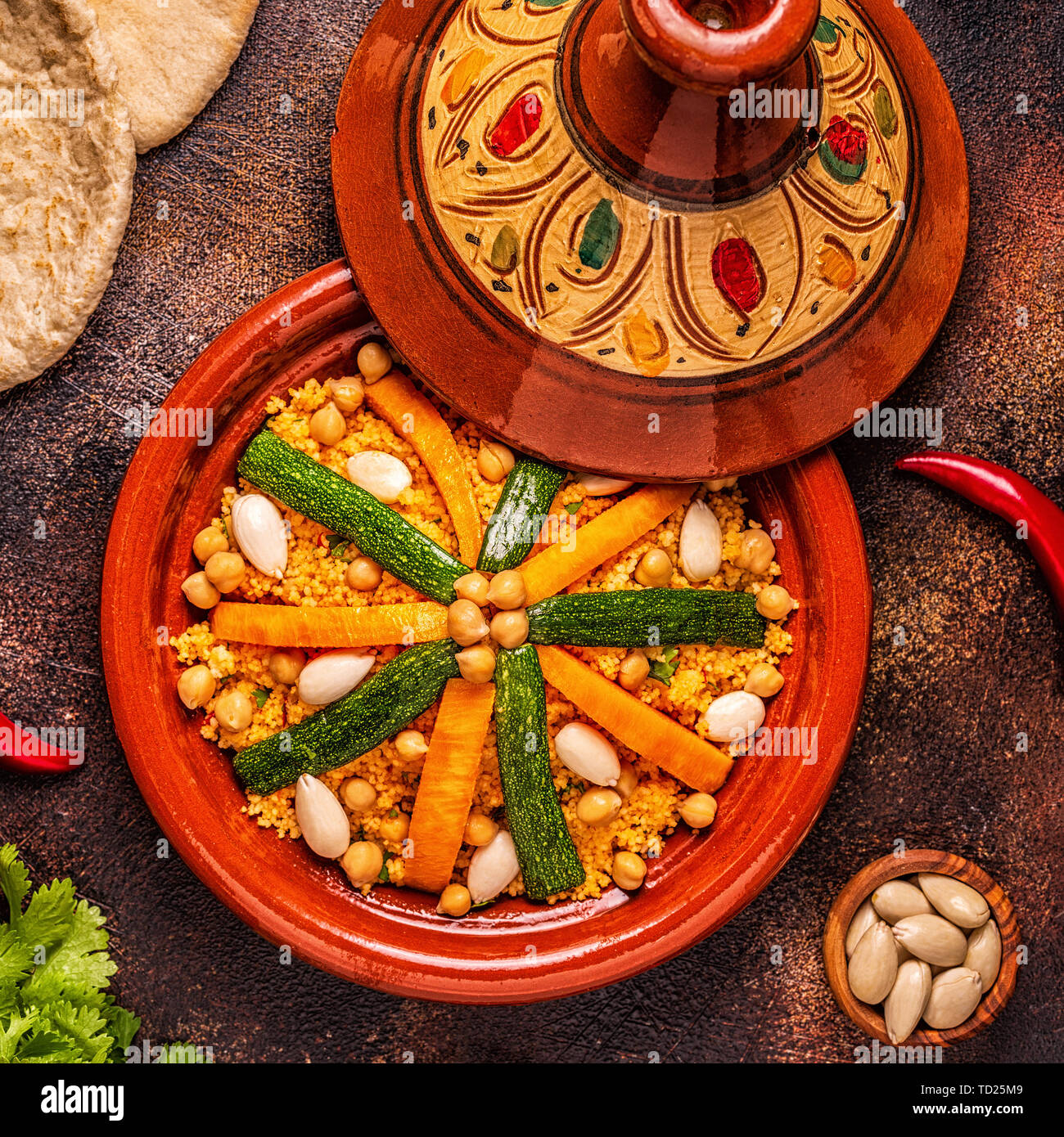 Vegetable tagine with almond and chickpea couscous, top view Stock