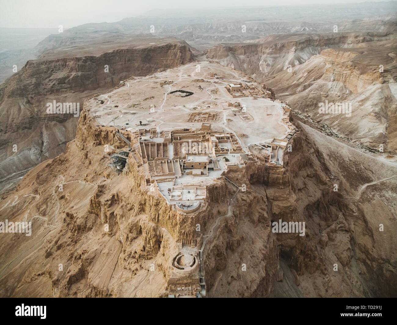 Aerial view of Masada fortress area, ancient fortification in the Southern District of Israel situated on top of isolated rock plateau, akin to a mesa Stock Photo