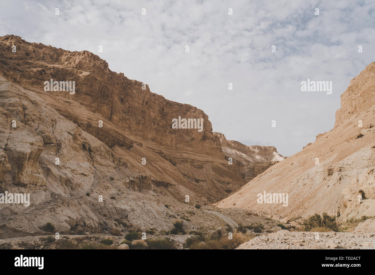 Beautiful landscape view of the Canyon in Israel taken during a fine day. Mountains, hills and cliffs against the cloudy sky in the Judean desert Stock Photo