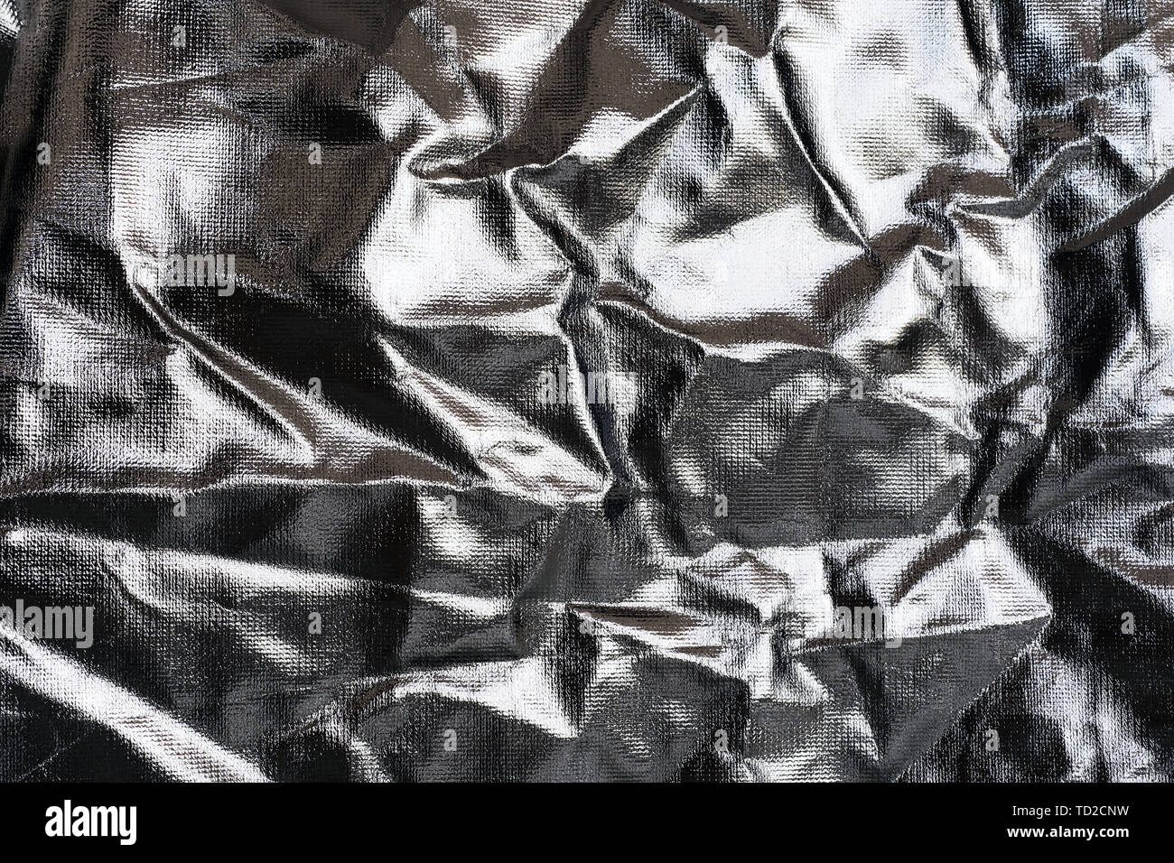 Textured silver foil background with shiny crumpled surface. Stock Photo