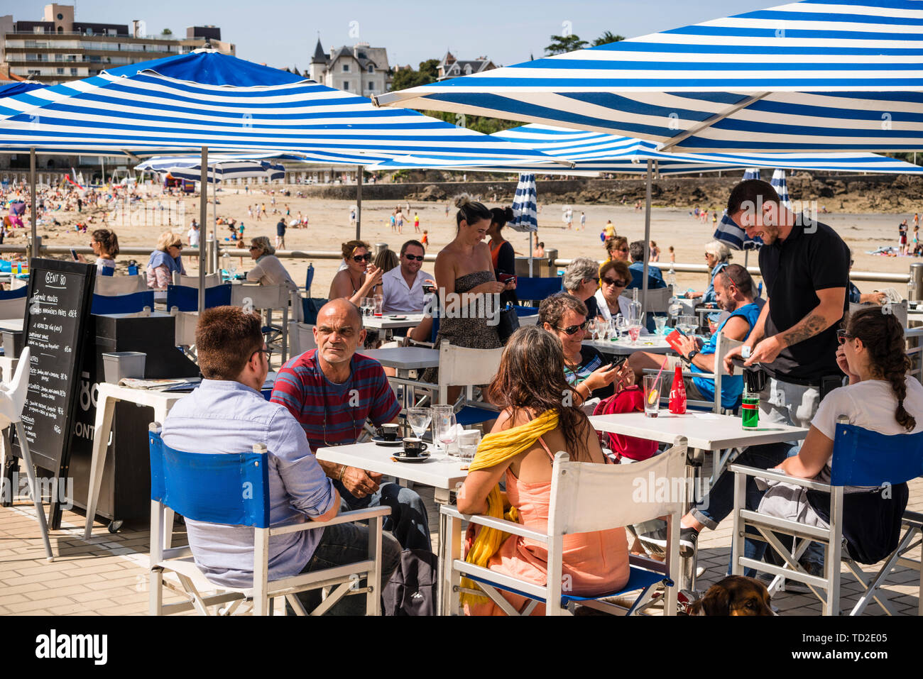 People at beach cafe, Dinard, Brittany, France Stock Photo