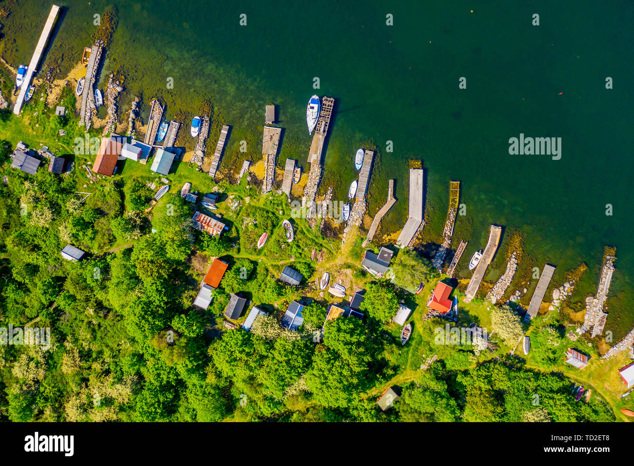 Straight down aerial of landscape full of small jetties, sheds and boats. Location Hasslo island in Blekinge archipelago, Sweden. Stock Photo