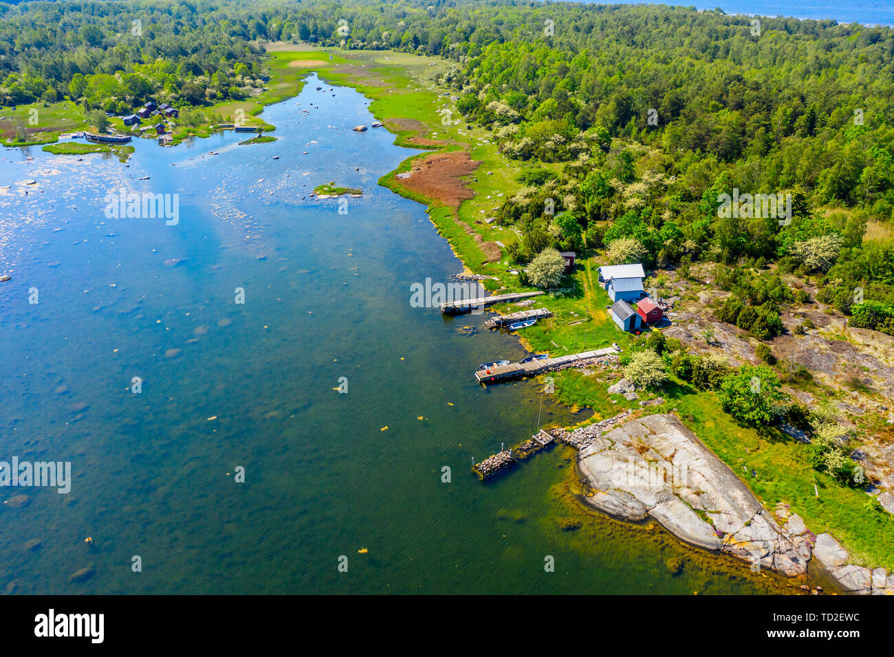 Aerial of coastal landscape with a small fishing camp on the shore of a bay. Location Hasslo island in Blekinge archipelago, Sweden. Stock Photo