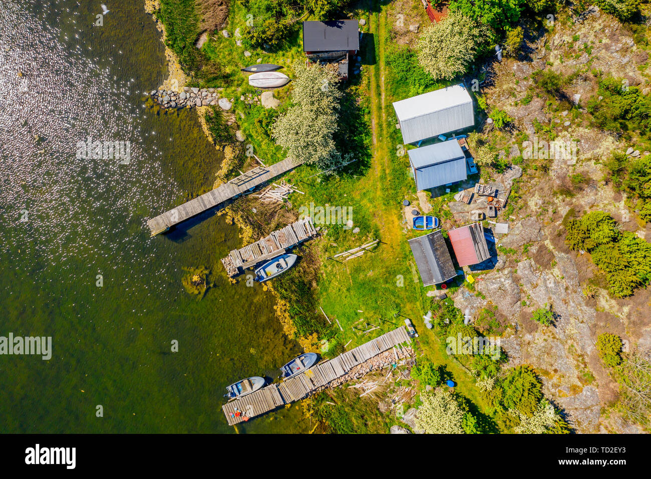 Aerial of a small fishing camp with sheds, boats and jetties. Location Hasslo island in Blekinge archipelago, Sweden. Stock Photo