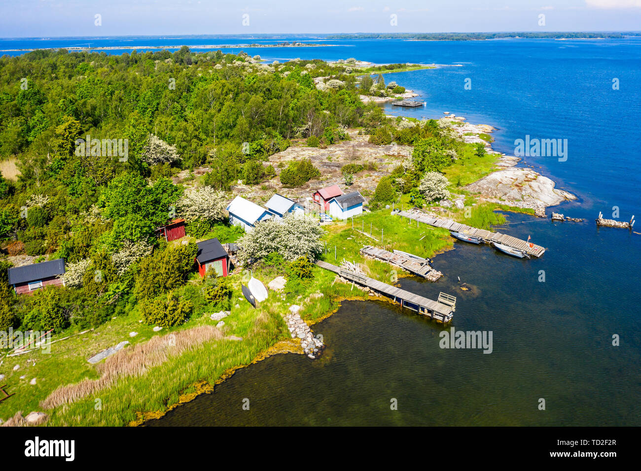 Typical view of Blekinge archipelago in southern Sweden on a sunny summer day. Traditional fishing sheds and jetties on green islands. Stock Photo