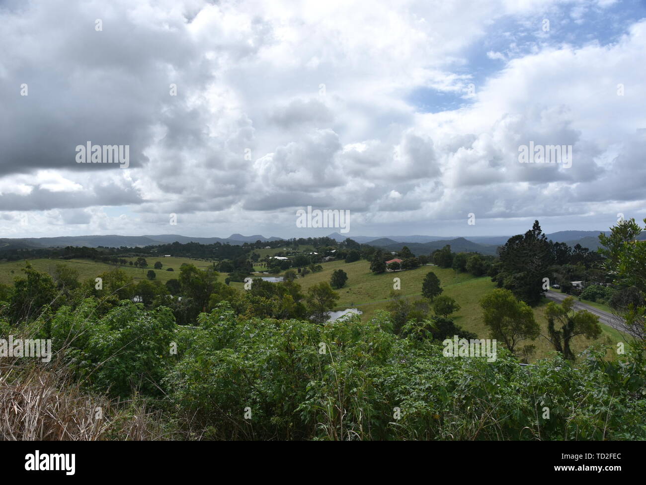 Broad panorama of the countryside on Sunshine Coast Hinterland. Grassy hills in the background. View from Kanyana Park on a cloudy day (Queensland, Au Stock Photo