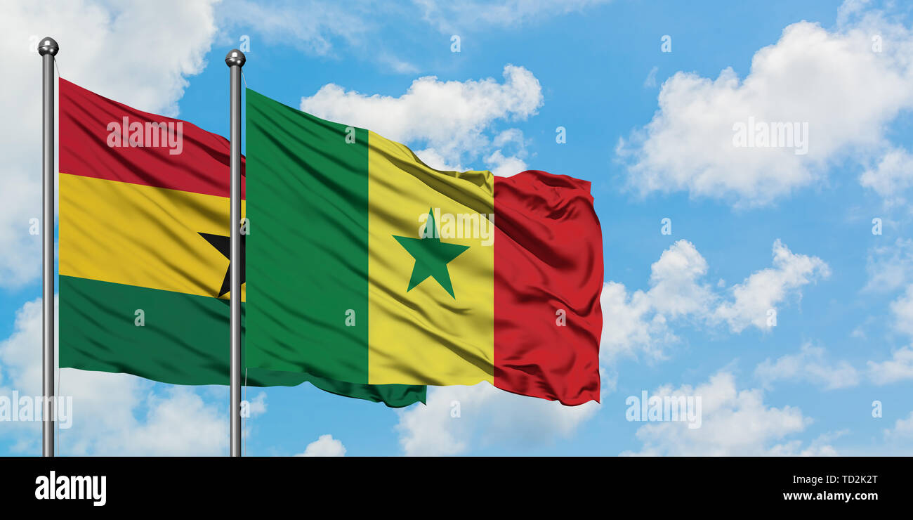 Ghana and Senegal flag waving in the wind against white cloudy blue sky together. Diplomacy concept, international relations. Stock Photo