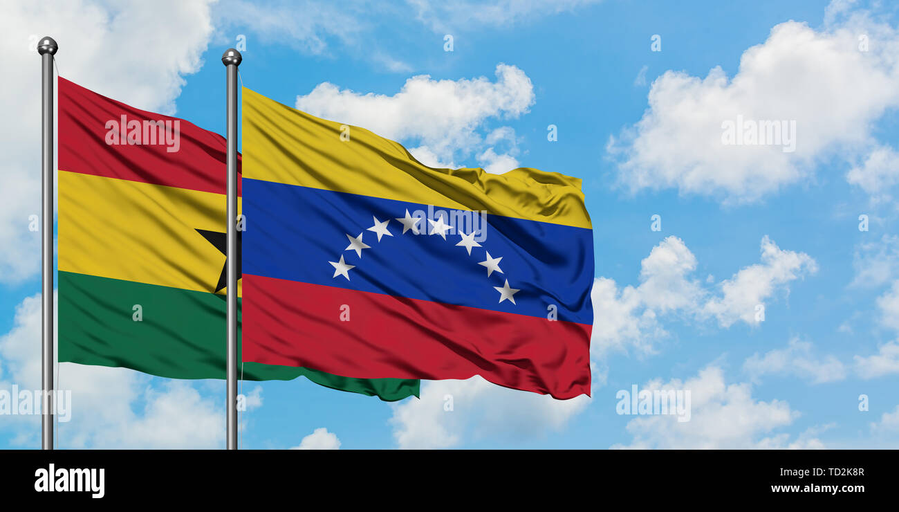 Ghana and Venezuela flag waving in the wind against white cloudy blue ...