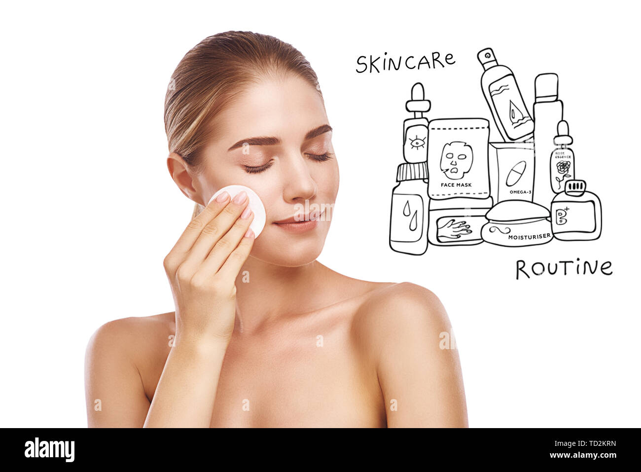 Your daily skincare routine. Portrait of pretty young woman removing makeup from her face with cotton pad while standing against white background with Stock Photo