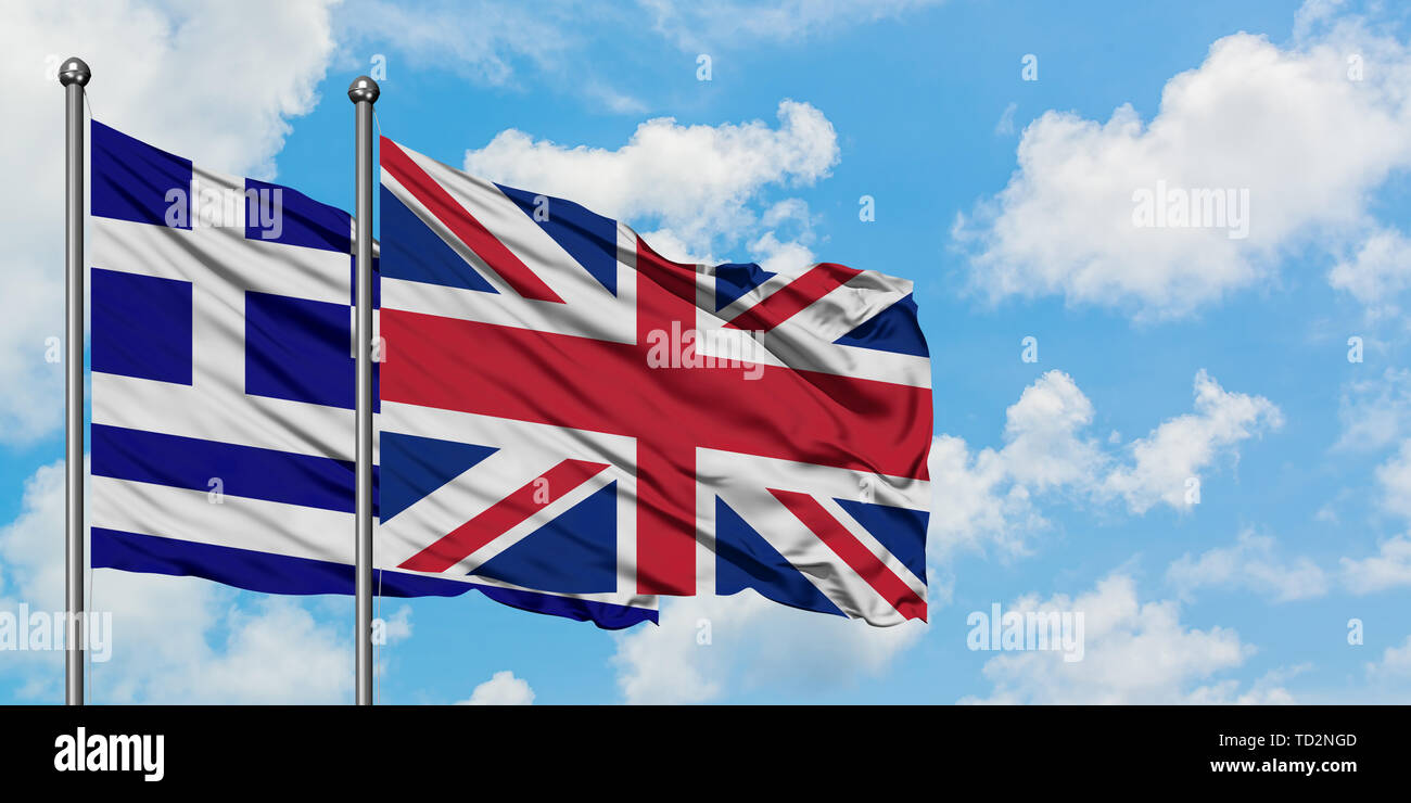 Greece and United Kingdom flag waving in the wind against white cloudy blue sky together