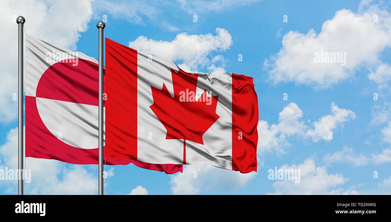 Greenland and Canada flag waving in the wind against white cloudy blue ...