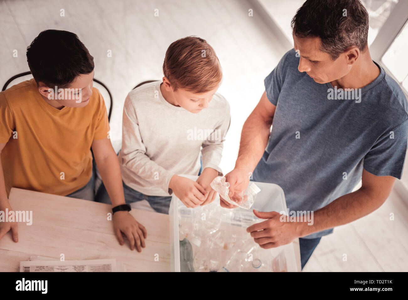 Caring father speaking with his children about plastic Stock Photo
