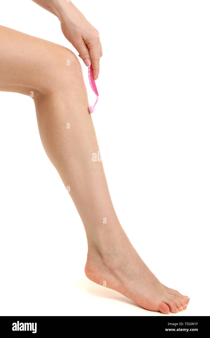 Beautiful woman is shaving her leg, isolated on white Stock Photo Alamy