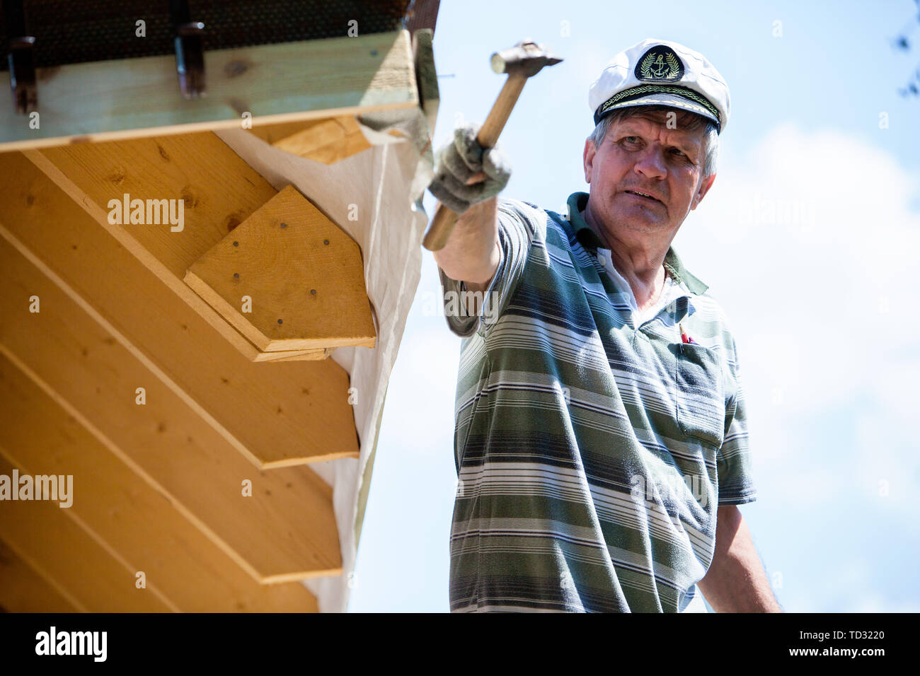 worker roofer builder working on roof structure on construction site Stock Photo