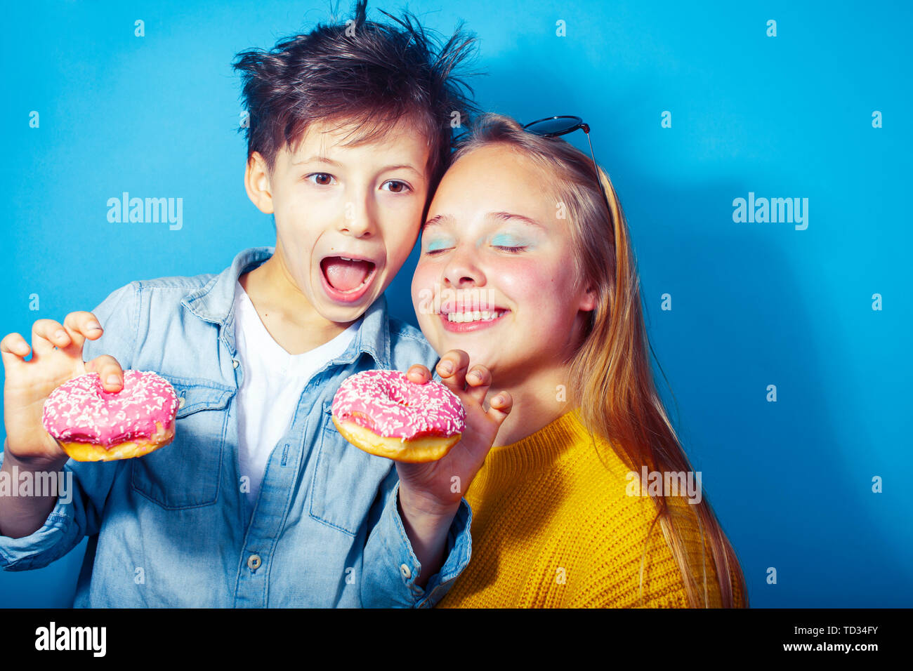 Chinese kids eating with chopsticks picture. Like siblings.