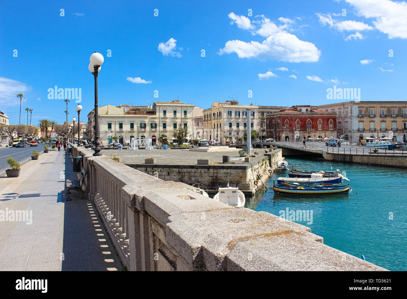 Syracuse, Sicily, Italy - Apr 10th 2019: Beautiful small harbor with boats on a sea between Syracuse and Ortigia Island photographed from bridge connecting both parts of historical city. Popular spot. Stock Photo