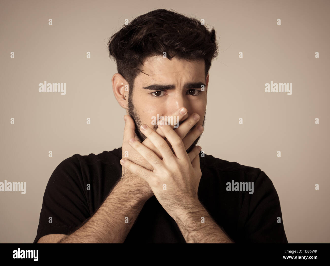 Young man feeling scared and shocked making fear anxiety gestures. Looking terrified and