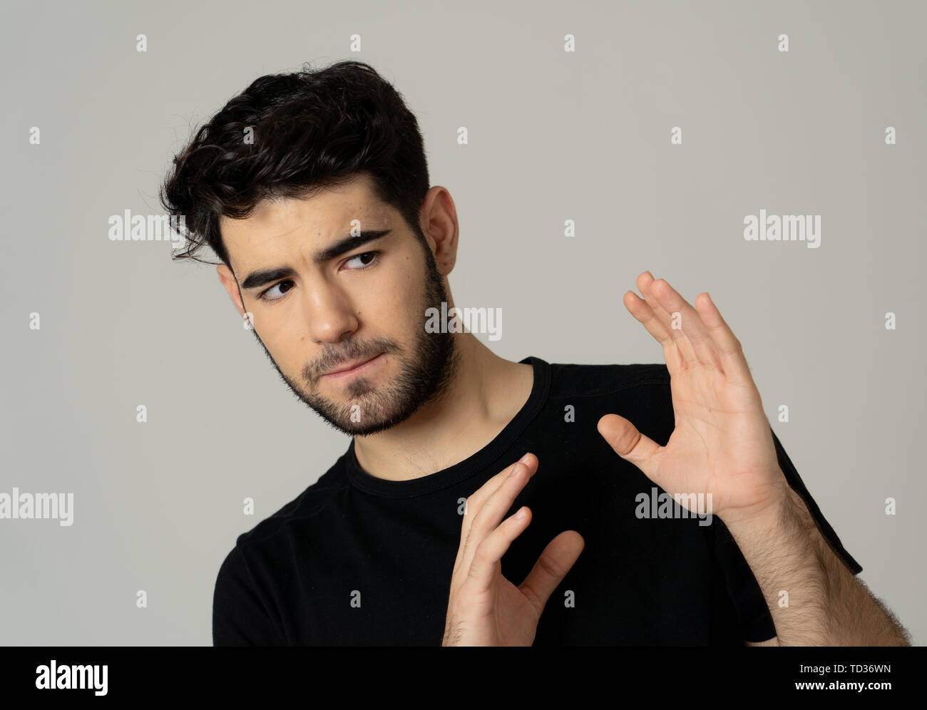 Young man feeling scared and shocked making fear anxiety gestures. Looking terrified and