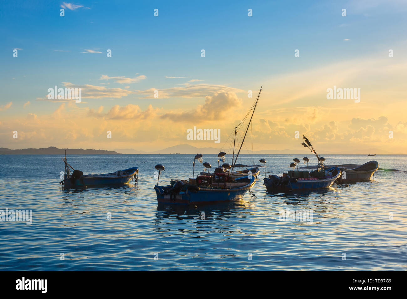 A fishing boat moored on the calm sea Stock Photo - Alamy