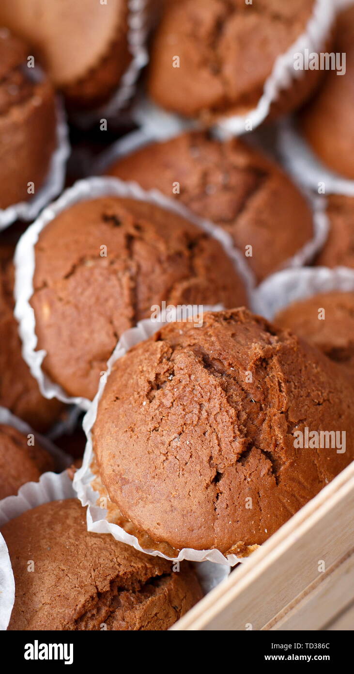 Close up of chocolate muffins in wooden tray Stock Photo - Alamy