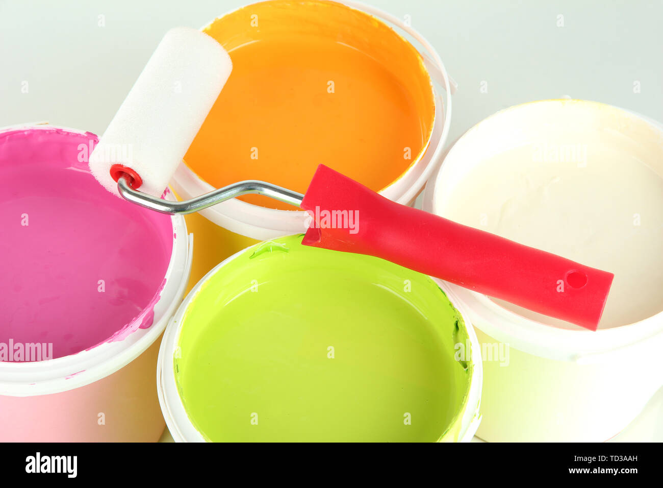 Set for painting: paint pots, paint-roller close up Stock Photo