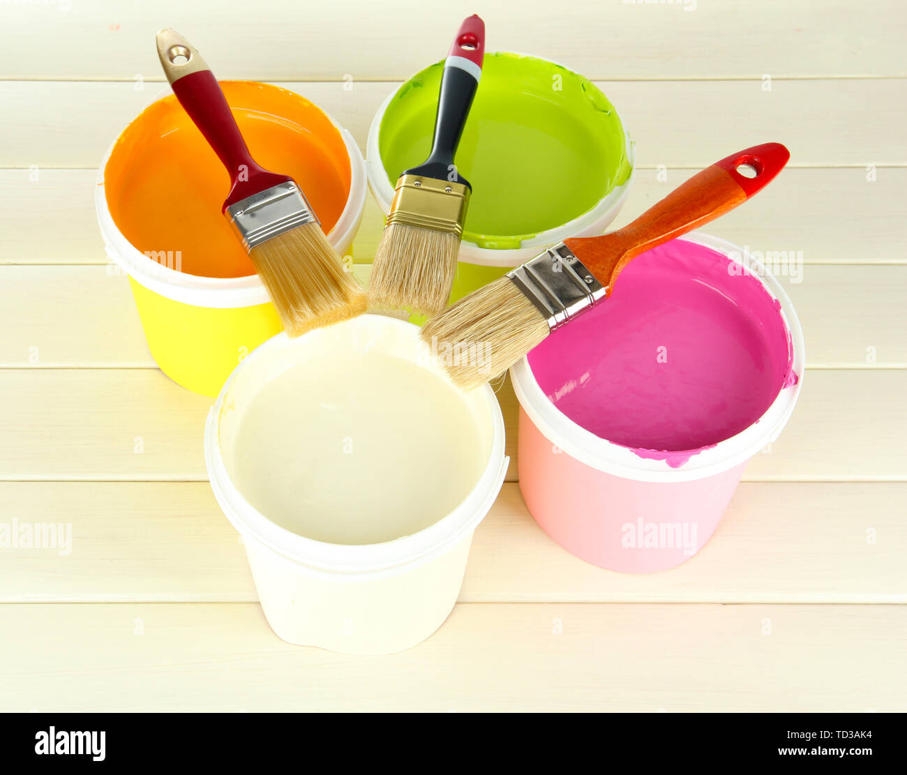 Set for painting paint pots, brushes on white wooden table Stock Photo
