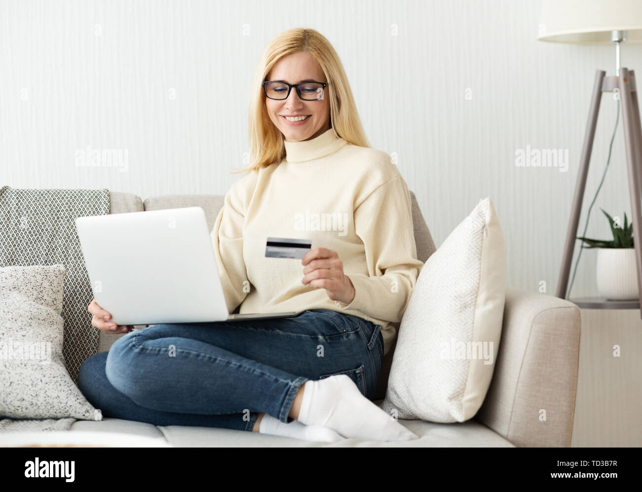 Online Shopping. Mature Woman Using Laptop And Holding Credit Card