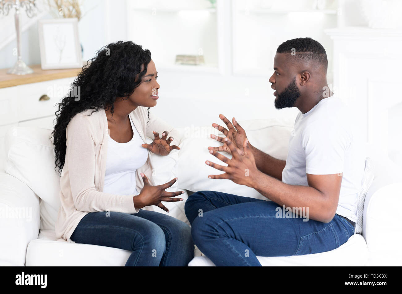 Man and woman quarreling, gesticulating and shouting at each other Stock Photo