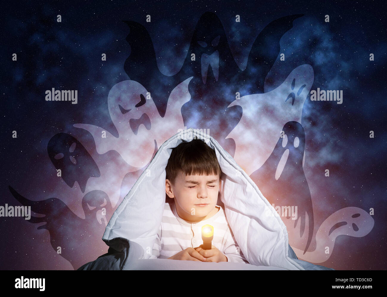 Young boy hiding under blanket Stock Photo - Alamy
