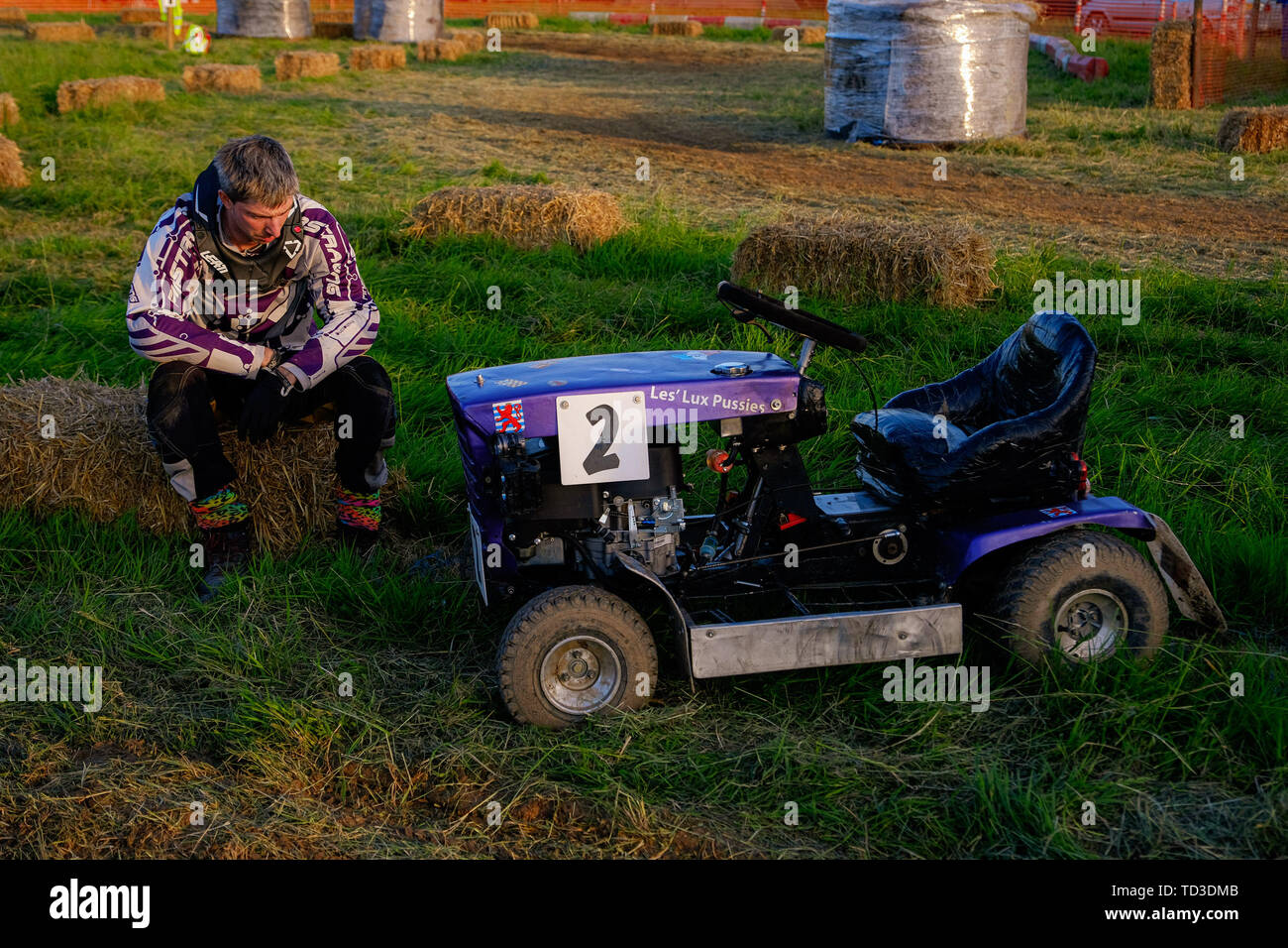 A driver sits by his machine before the start (Le-mans style start) at the British Lawn Mower Racing Assoc 12 hour Race ( BLMRA  12th August 2017. Stock Photo