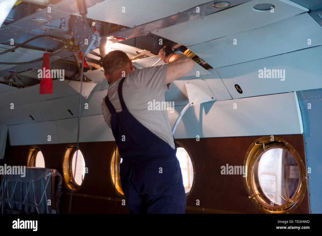 Worker maintaining a Mi-8 helicopter. Tyumen Stock Photo