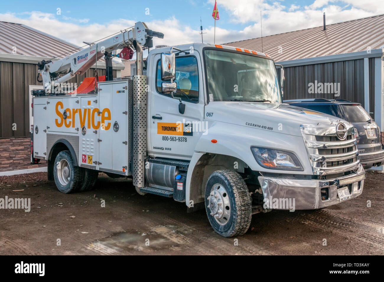 A Hino 258 utility vehicle fitted with a Stellar 5521 crane in Forteau, Labrador, Canada Stock Photo