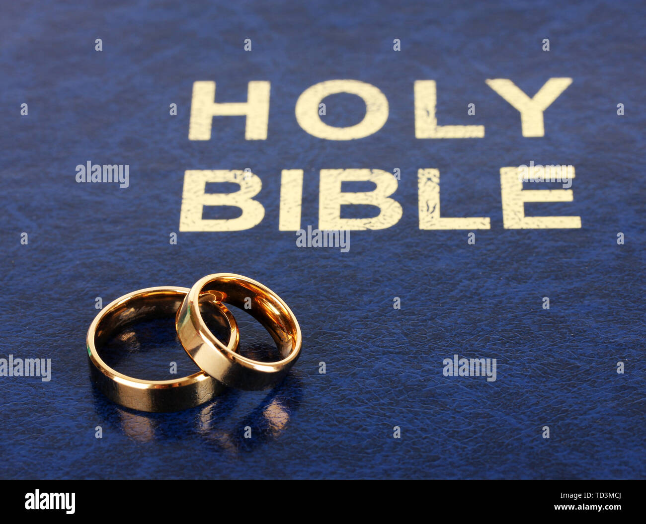 Wedding rings on bible Stock Photo Alamy