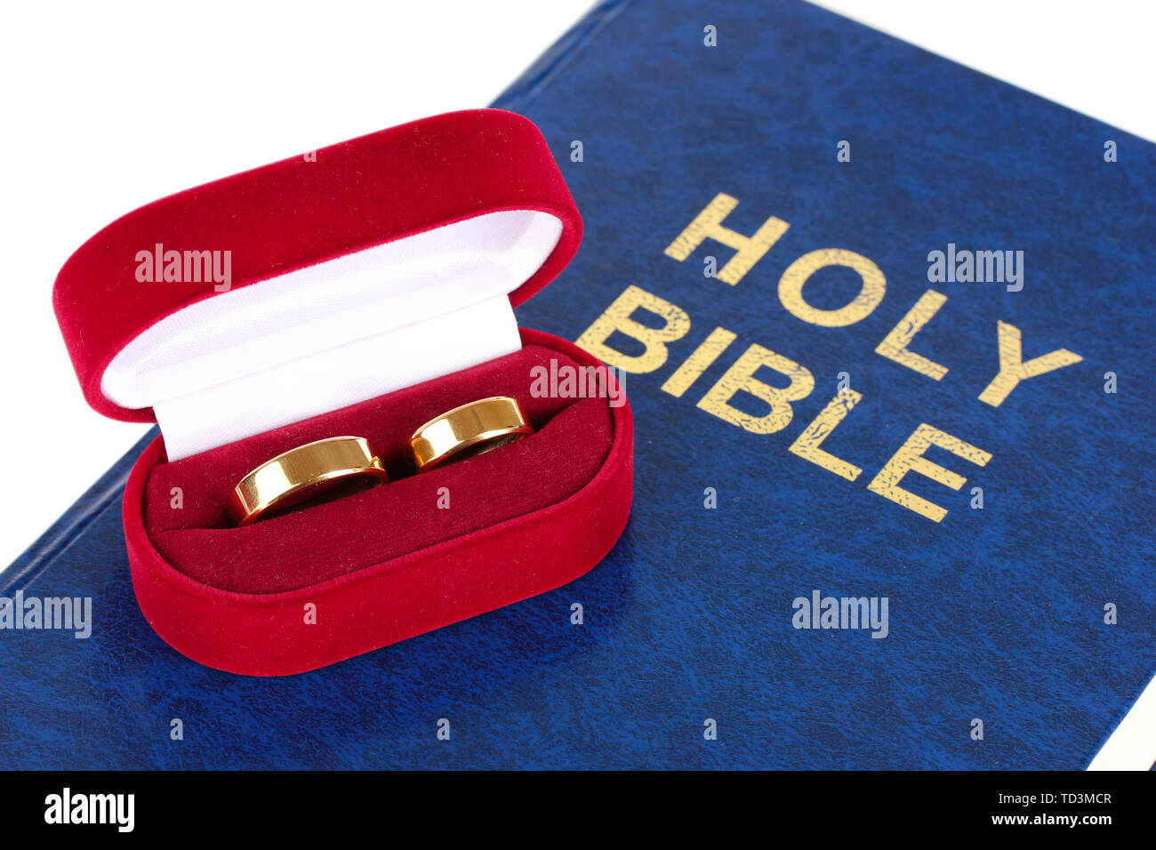 Wedding rings on bible isolated on white Stock Photo
