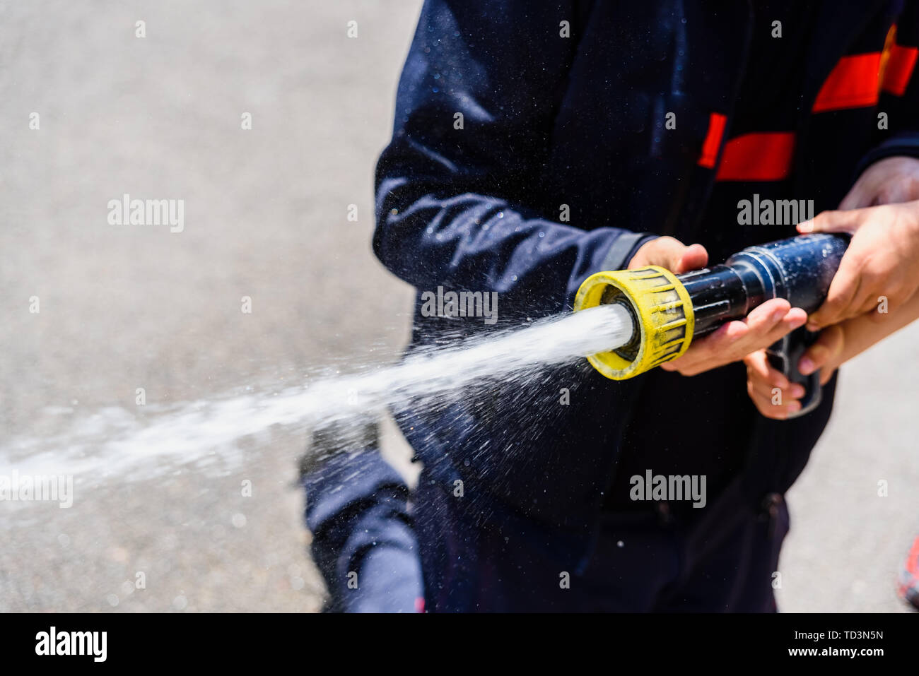 Male firefighter throwing water hires stock photography and images Alamy