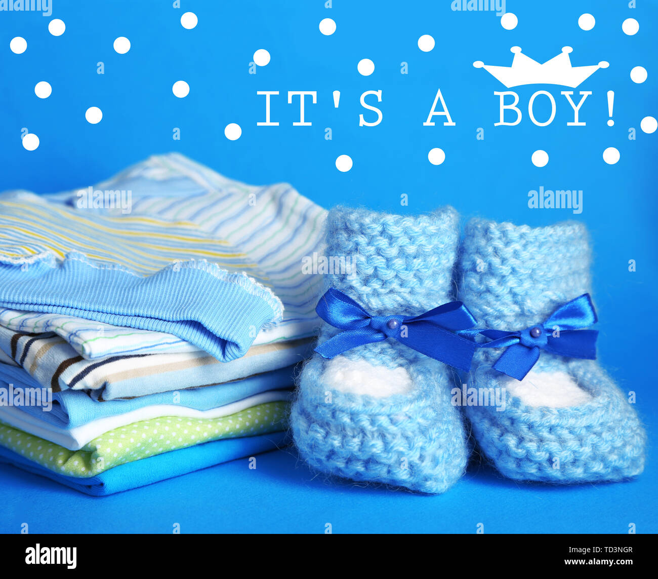Pile of baby clothes on blue background Stock Photo Alamy