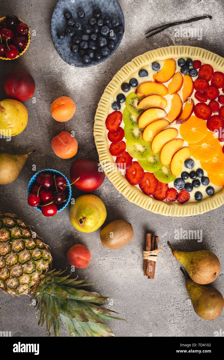 Organic Fruit Tart Pie Preparation, Fresh Dough and Colorful Fruits Ready to Bake. Healthy Food Concept. Stock Photo