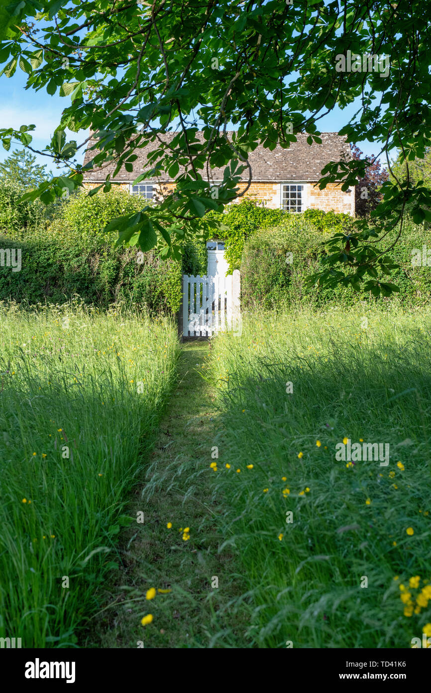 Mown Path Through Long Grass To A Cotswold Stone Cottage Wyck